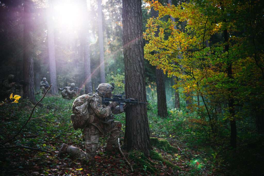 US troops in a forest.