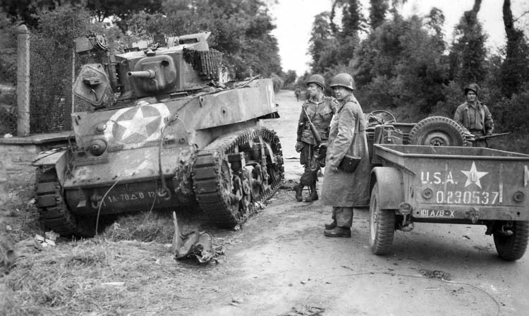 Paratroopers next to the knocked out M5A1 Stuart at Dead Man's Corner.
